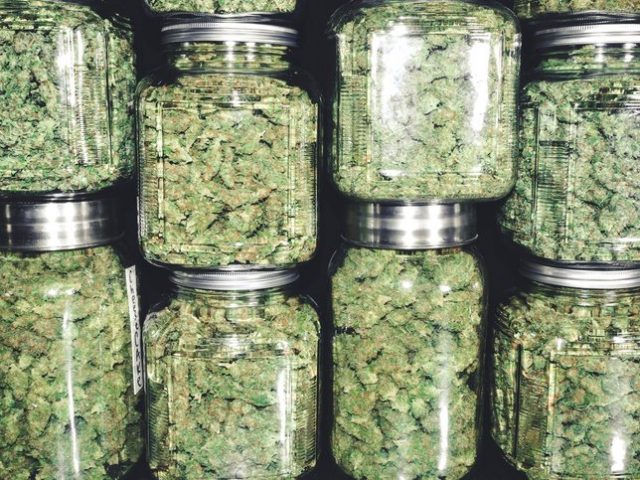 Marijuana Buds in Glass Jar Stack Rhode Island Marijuana Laws